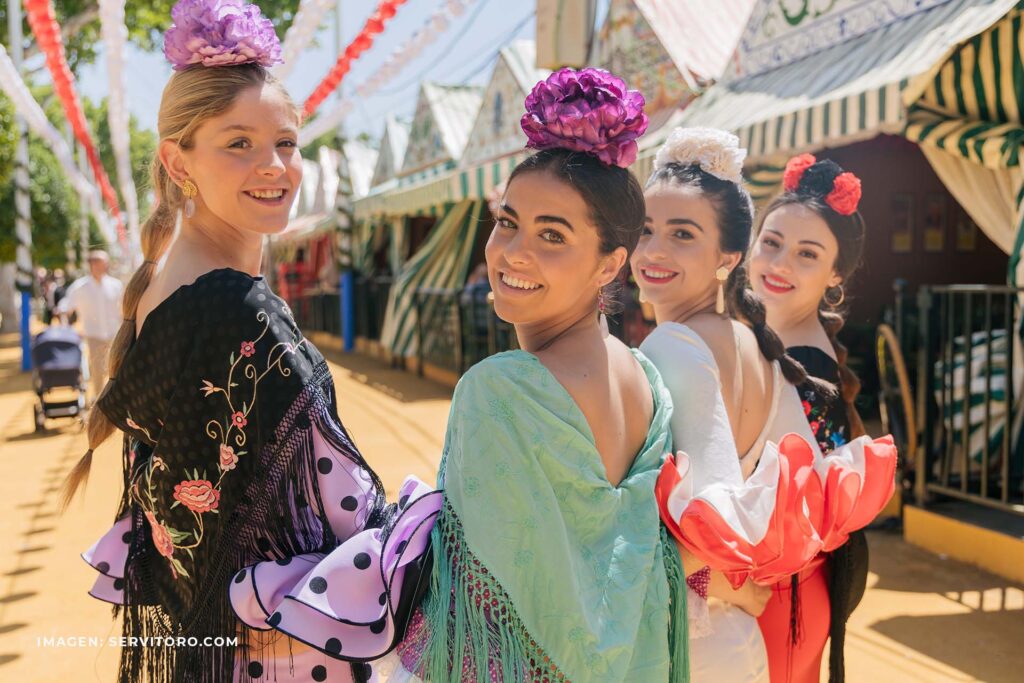 Chicas con traje de flamenca en la feria